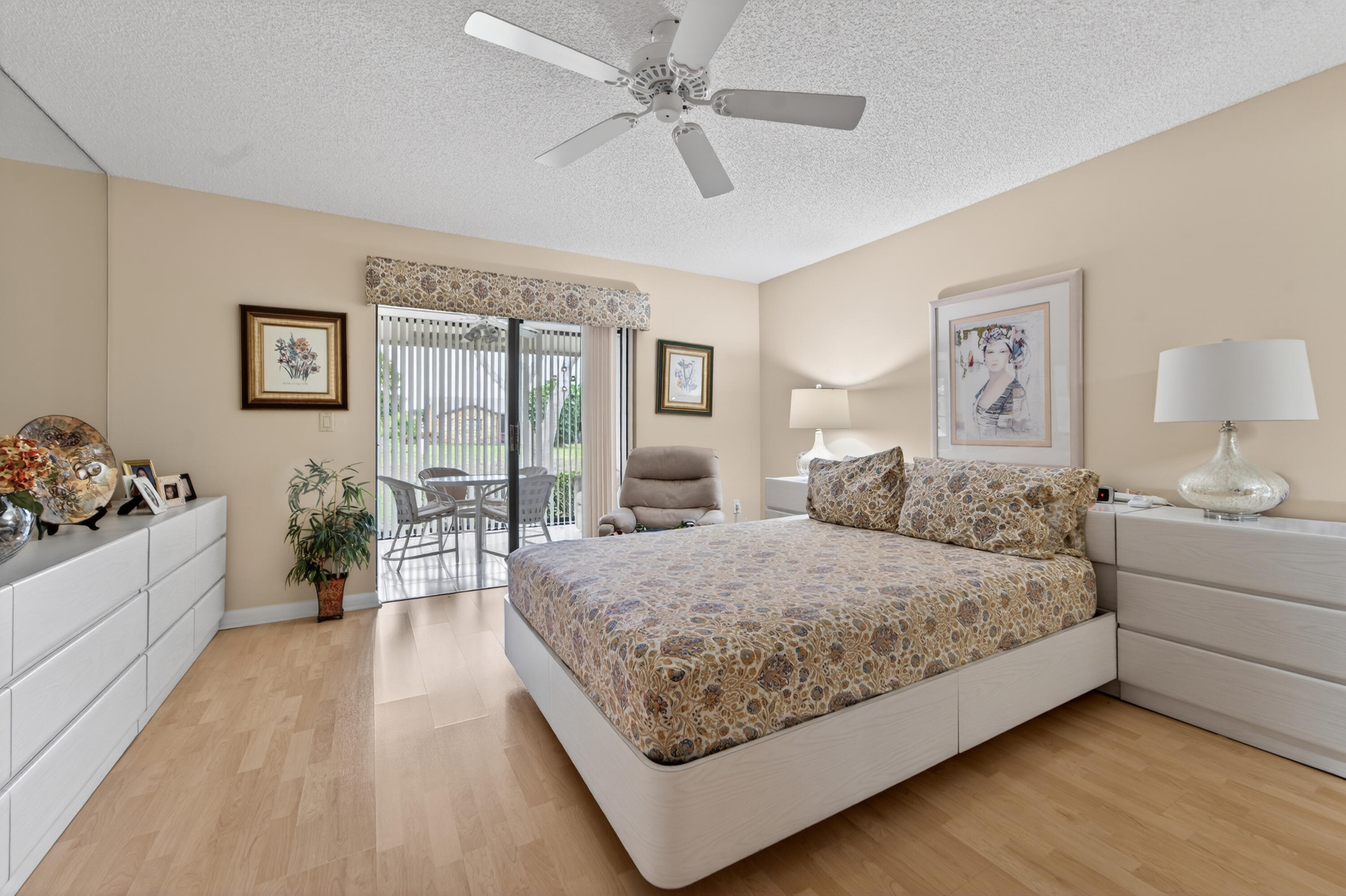 6224 Kings Gate Circle Delray Beach, FL 33484 - Photo 5 of 53 a room with a large bed and a chandelier fan