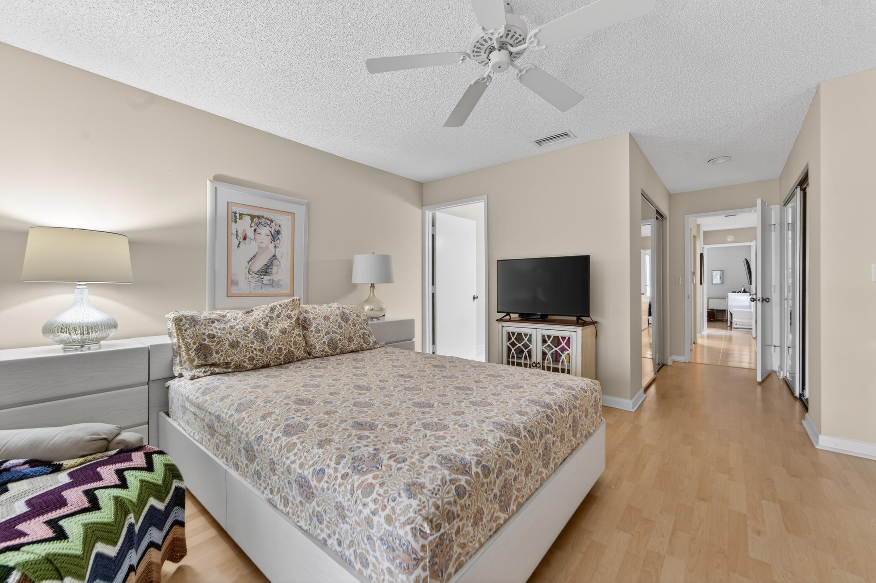 6224 Kings Gate Circle Delray Beach, FL 33484 - Photo 6 of 53 a bedroom with a large bed and a flat screen tv