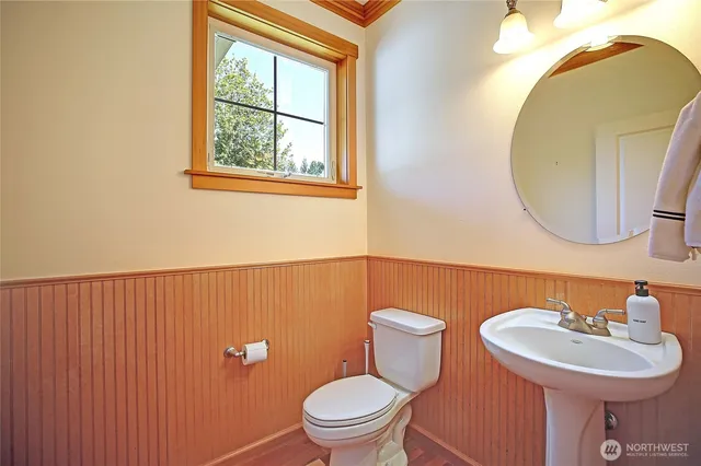 a bathroom with a sink a mirror and a toilet