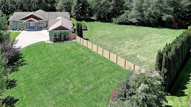 an aerial view of residential house with outdoor space and swimming pool