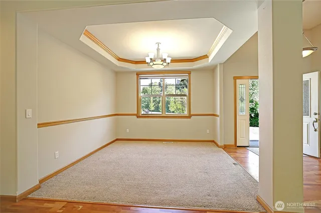 an empty room with windows and chandelier