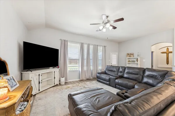a living room with furniture and a flat screen tv