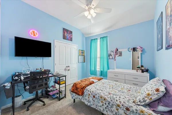a bedroom with a bed and a flat screen tv