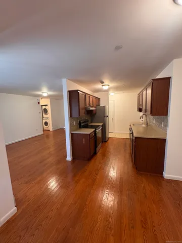 a kitchen with stainless steel appliances wooden floors and refrigerator