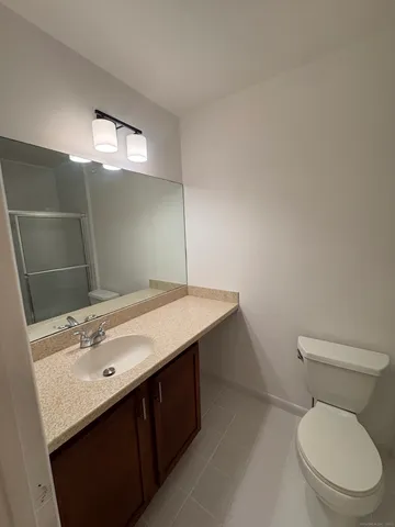 a bathroom with a sink vanity and toilet