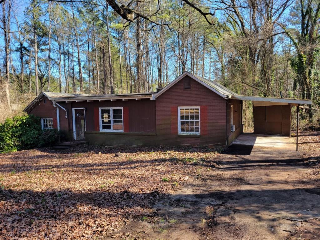 672 Rowland Road Stone Mountain, GA 30083 - Photo 1 of 1 a view of a house with a yard