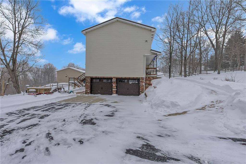 750 Old Millcreek Road Hookstown, PA 15050 - Photo 2 of 44 Two car garage. There is an asphalt driveway leading to the garage.