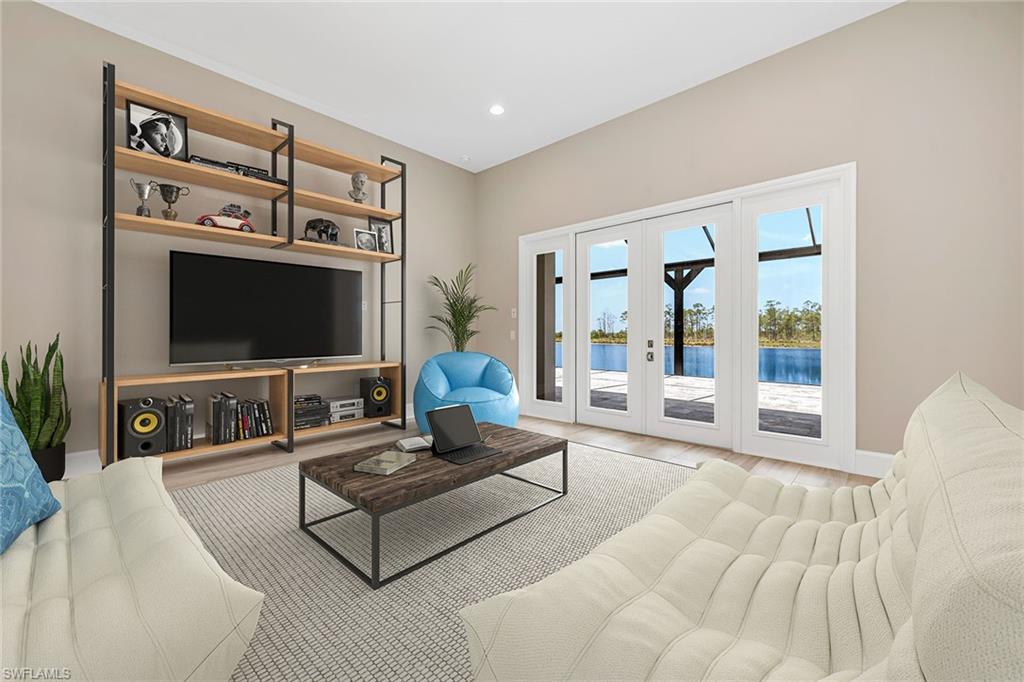 8871 Nevis Way Naples, FL 34112 - Photo 16 of 50 a living room with furniture and a flat screen tv