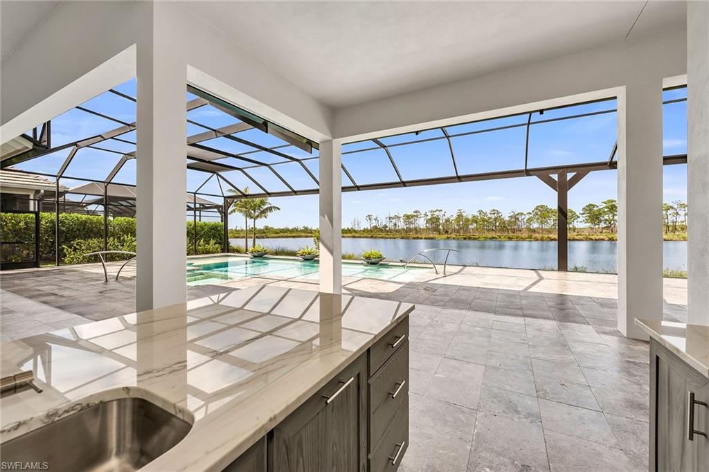 8871 Nevis Way Naples, FL 34112 - Photo 19 of 50 a view of a swimming pool with a patio