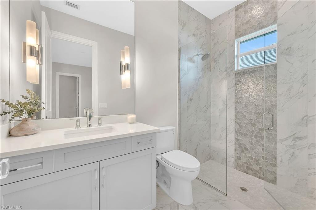 8871 Nevis Way Naples, FL 34112 - Photo 20 of 50 a bathroom with a sink a toilet and shower