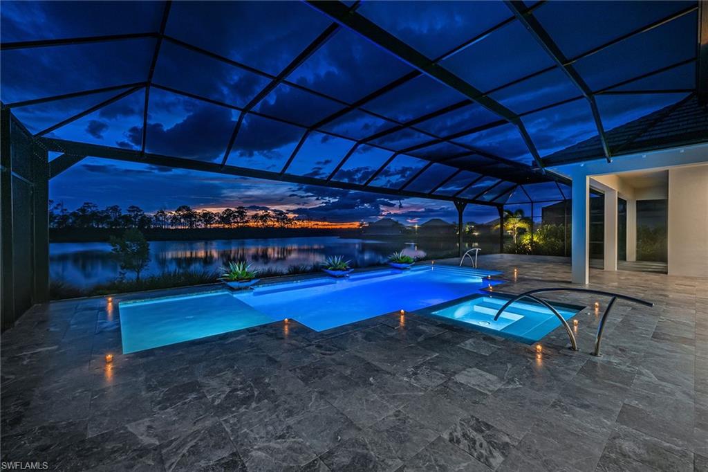 8871 Nevis Way Naples, FL 34112 - Photo 2 of 50 a view of a swimming pool with a patio