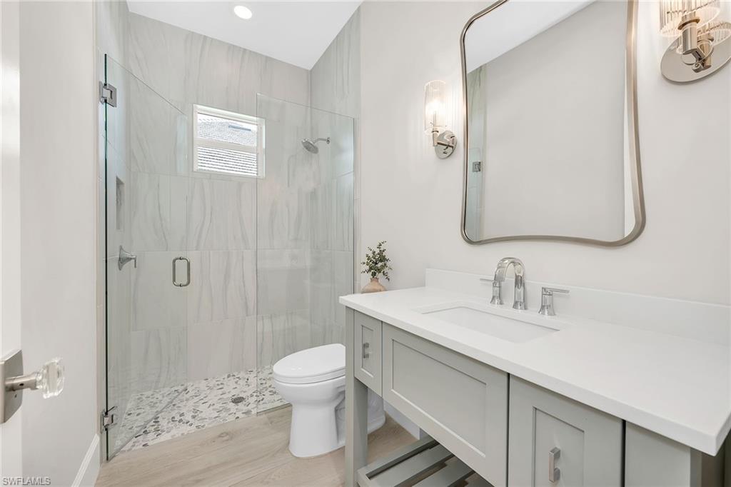 8871 Nevis Way Naples, FL 34112 - Photo 23 of 50 a bathroom with a sink toilet and shower