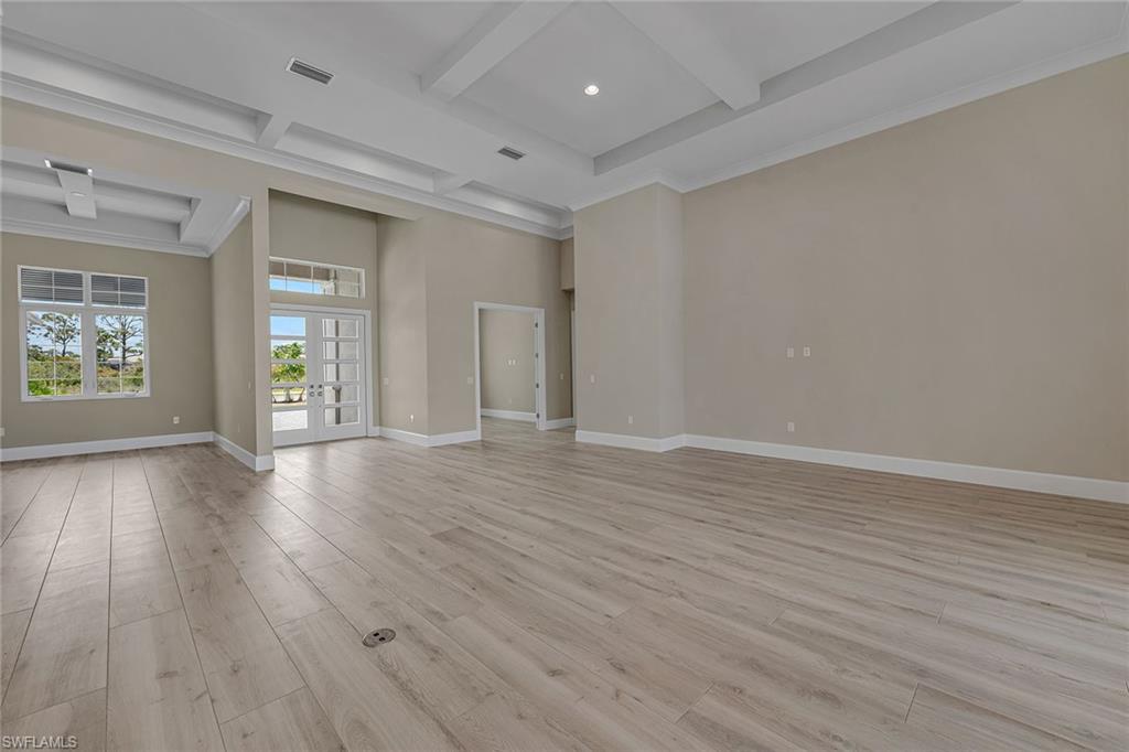 8871 Nevis Way Naples, FL 34112 - Photo 24 of 50 wooden floor in an empty room with a window