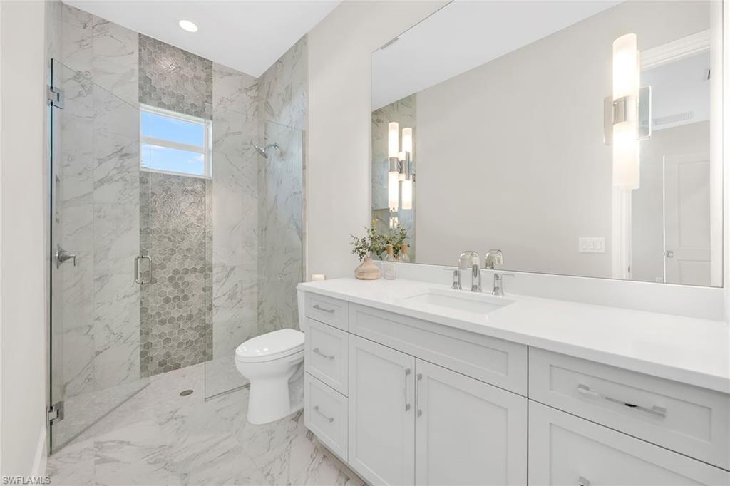 8871 Nevis Way Naples, FL 34112 - Photo 25 of 50 a bathroom with a sink a toilet and shower