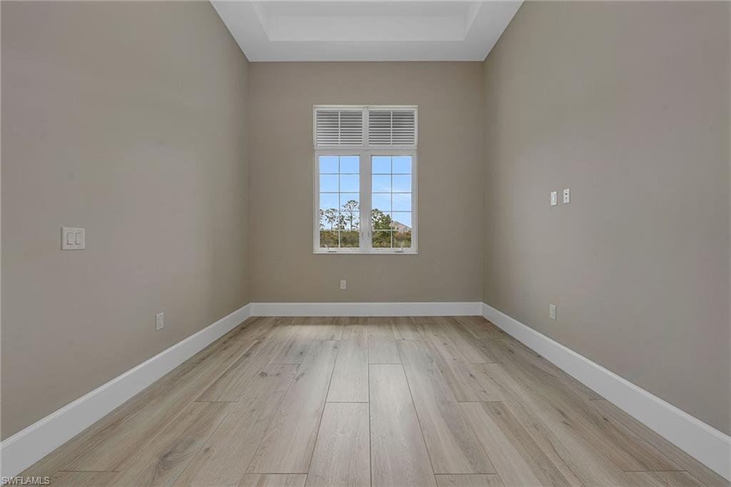 8871 Nevis Way Naples, FL 34112 - Photo 27 of 50 wooden floor in an empty room with a window