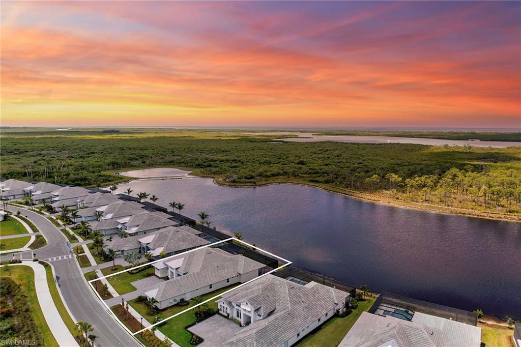 8871 Nevis Way Naples, FL 34112 - Photo 28 of 50 an aerial view of residential houses with outdoor space and ocean view
