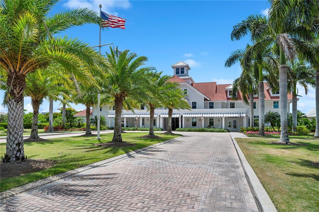 8871 Nevis Way Naples, FL 34112 - Photo 34 of 50 a view of a white house with a yard table and chairs