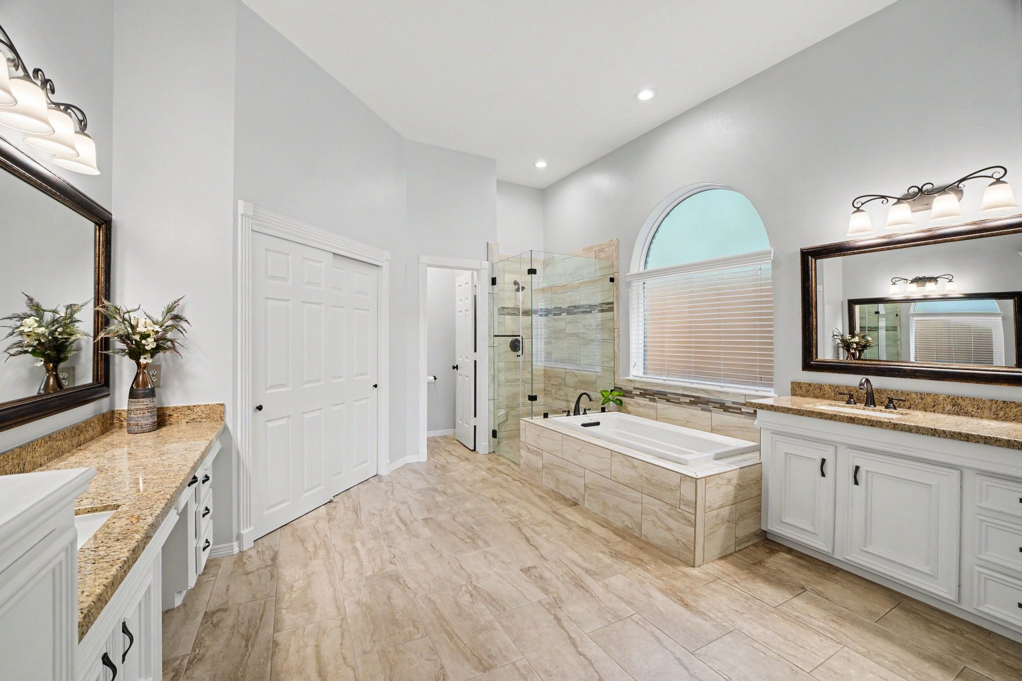 3411 Fir Forest Drive Spring, TX 77388 - Photo 18 of 39 Large spa-like ensuite primary bathroom has been fully updated with new countertops, frameless glass shower, and large tub. The primary bathroom also has TWO large walk-in closets!