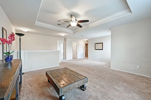 a spacious bedroom with a bed and a chandelier