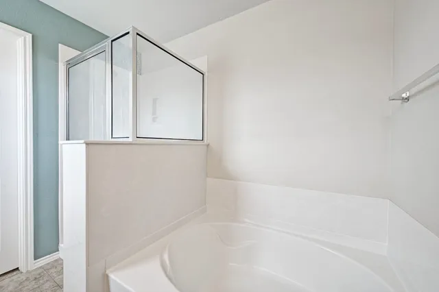 an empty room with furniture and fan