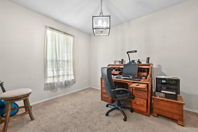 a view of a livingroom with furniture and staircase