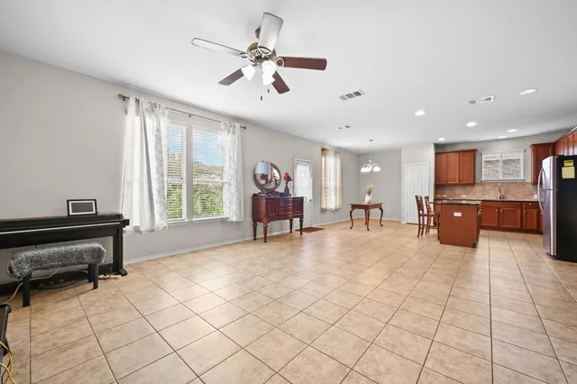 a kitchen with stainless steel appliances granite countertop a refrigerator and a stove top oven