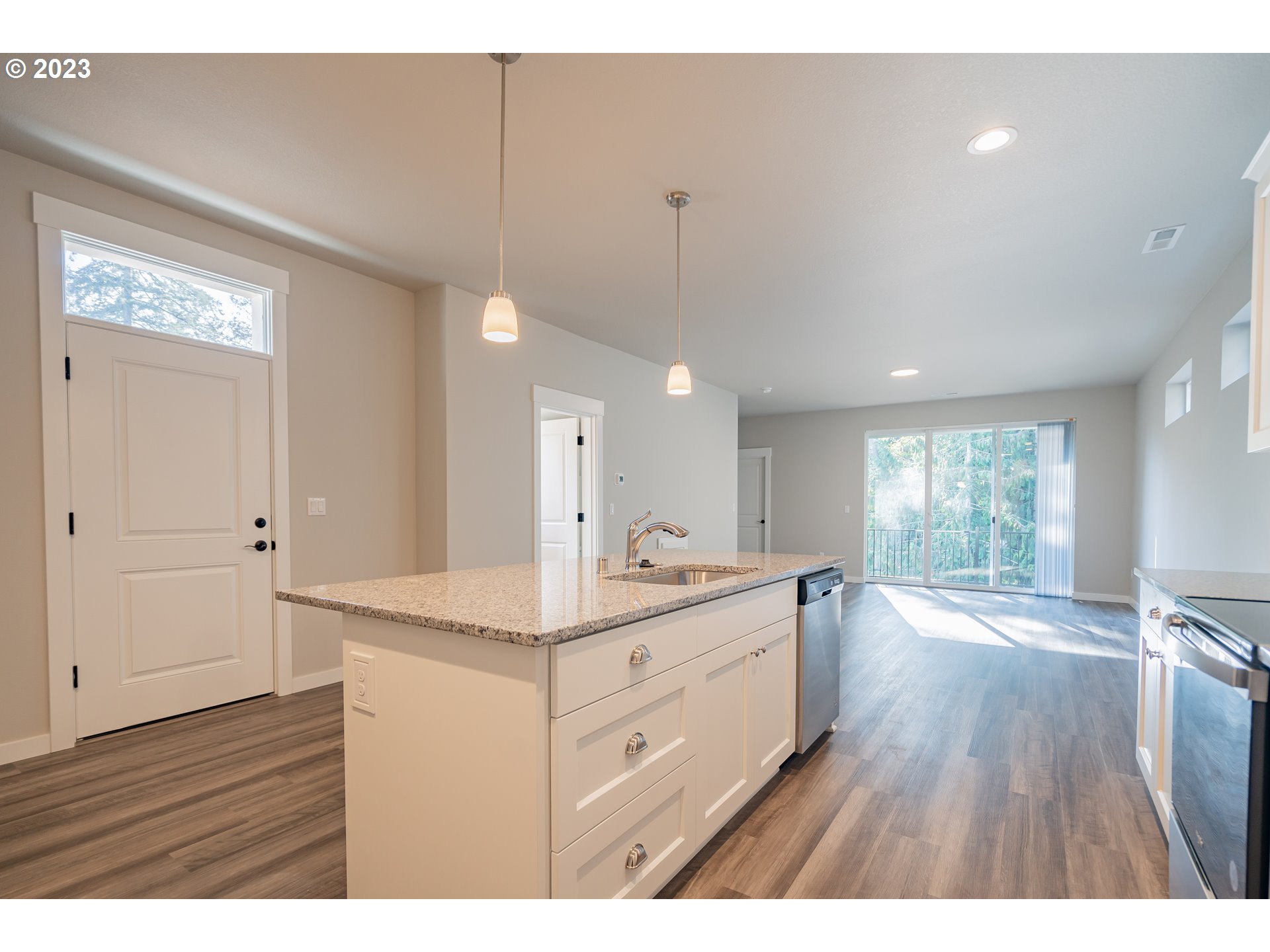 7017 South 13th Street Ridgefield, WA 98642 - Photo 4 of 33 a kitchen with a sink cabinets and wooden floor