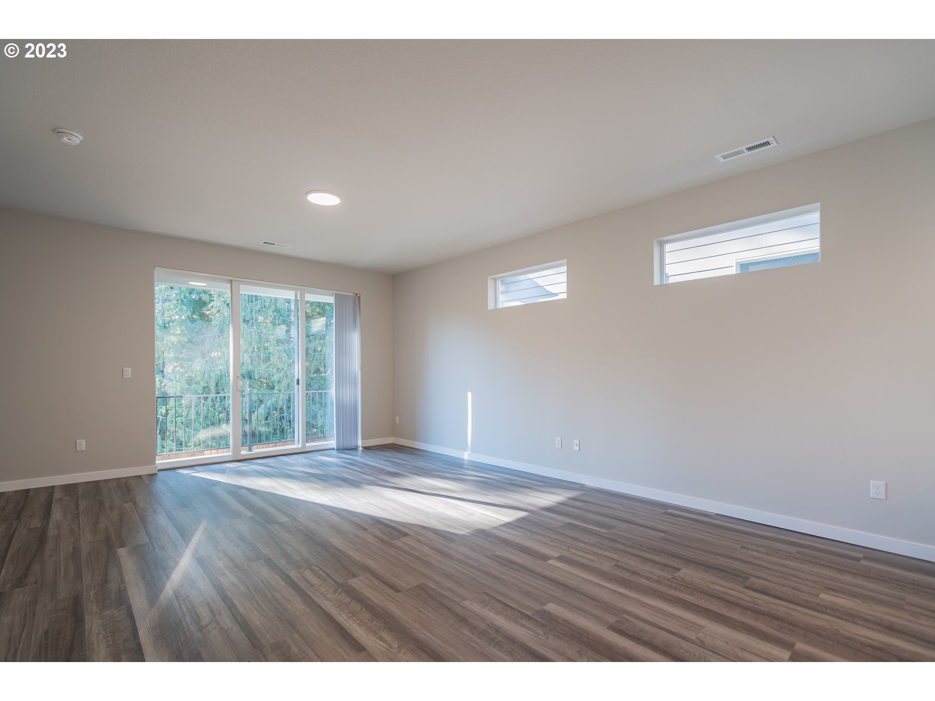 7017 South 13th Street Ridgefield, WA 98642 - Photo 10 of 33 a view of an empty room with wooden floor and a window