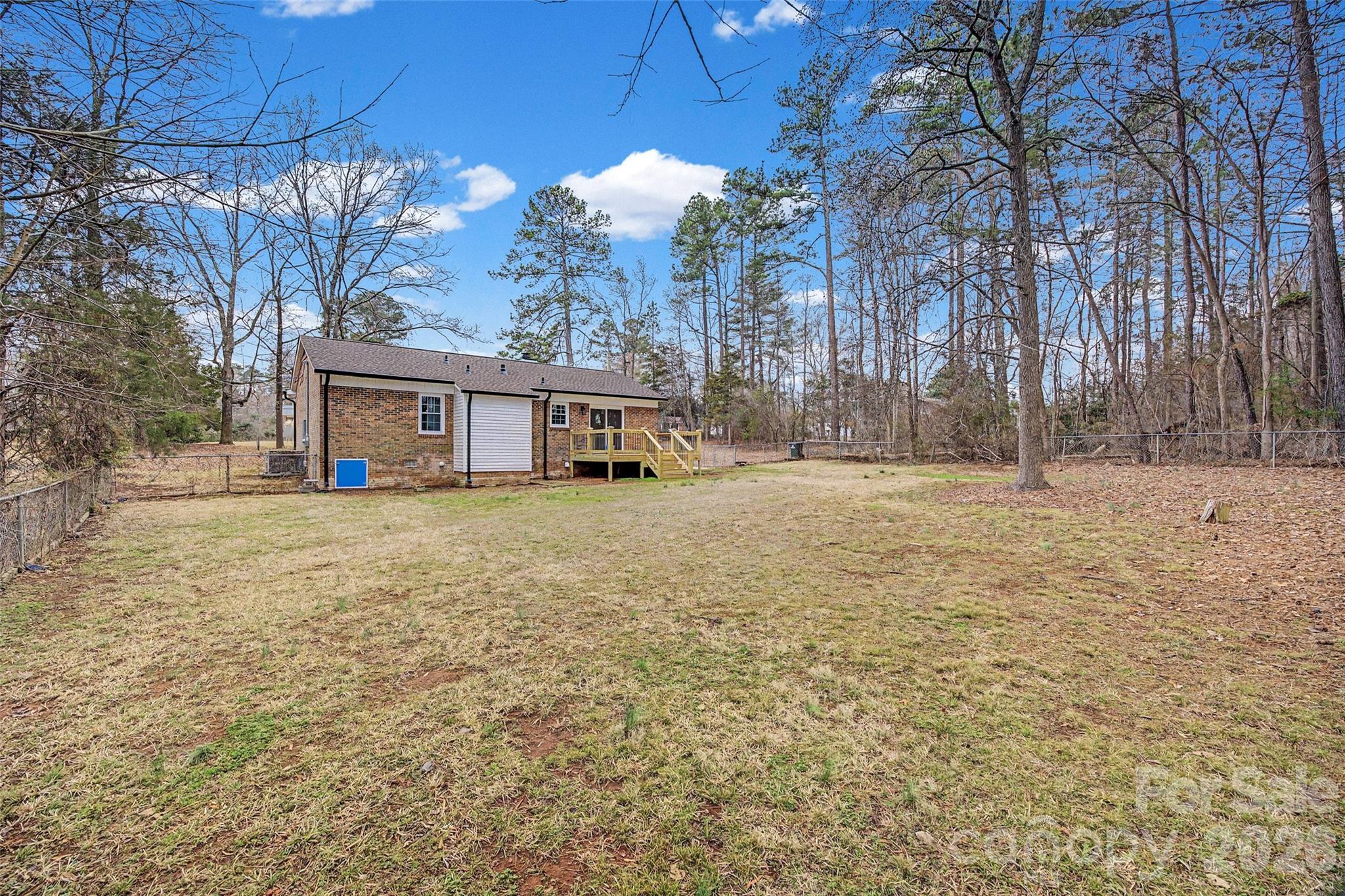 1135 Princeton Road Rock Hill, SC 29730 - Photo 18 of 20 a backyard of a house with large trees and outdoor seating