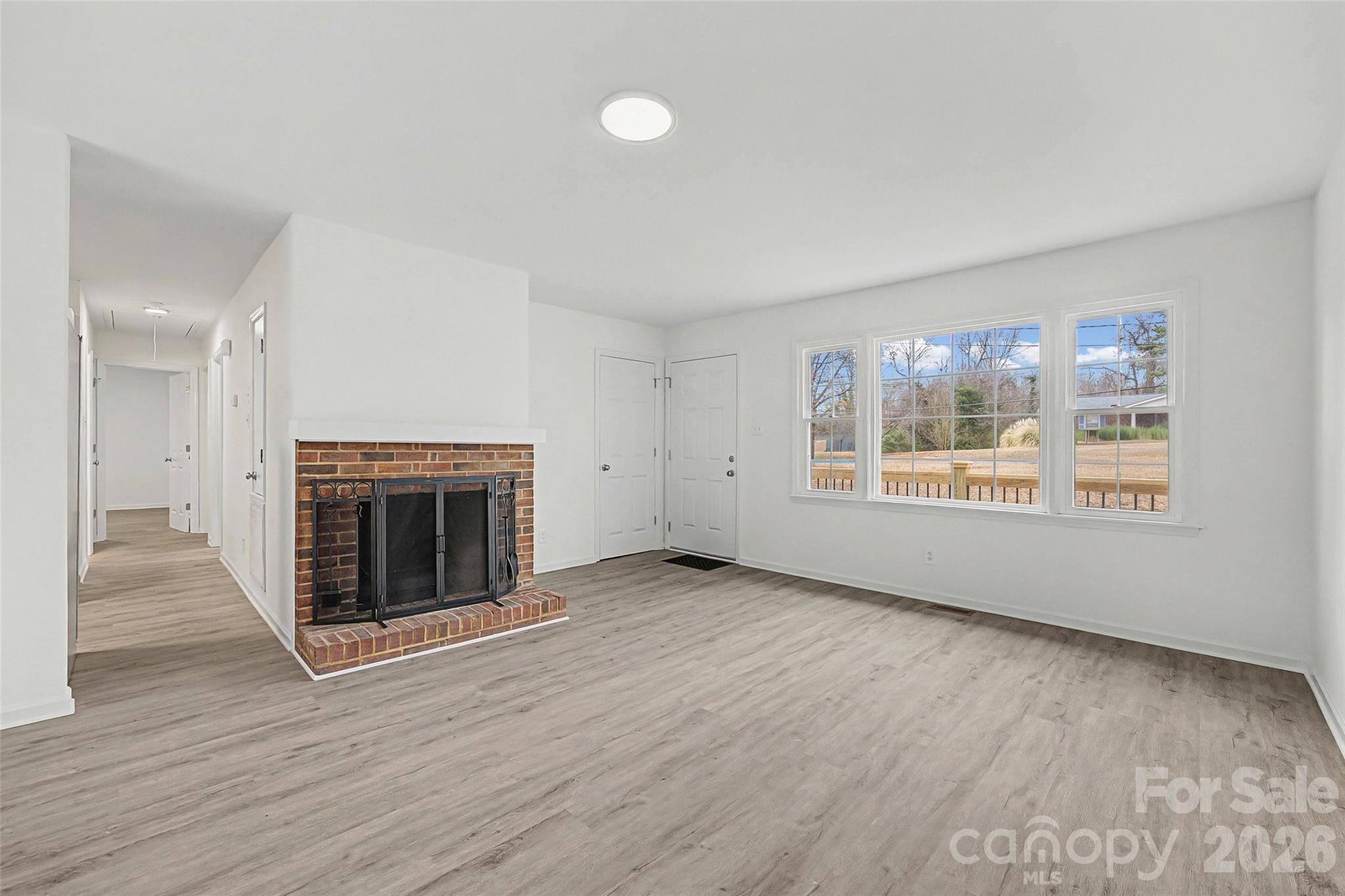 1135 Princeton Road Rock Hill, SC 29730 - Photo 2 of 20 wooden floor fireplace and windows in an empty room