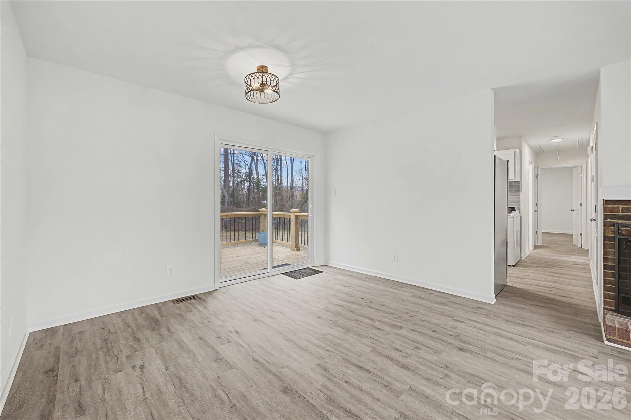 1135 Princeton Road Rock Hill, SC 29730 - Photo 3 of 20 a view of an empty room with wooden floor and a window