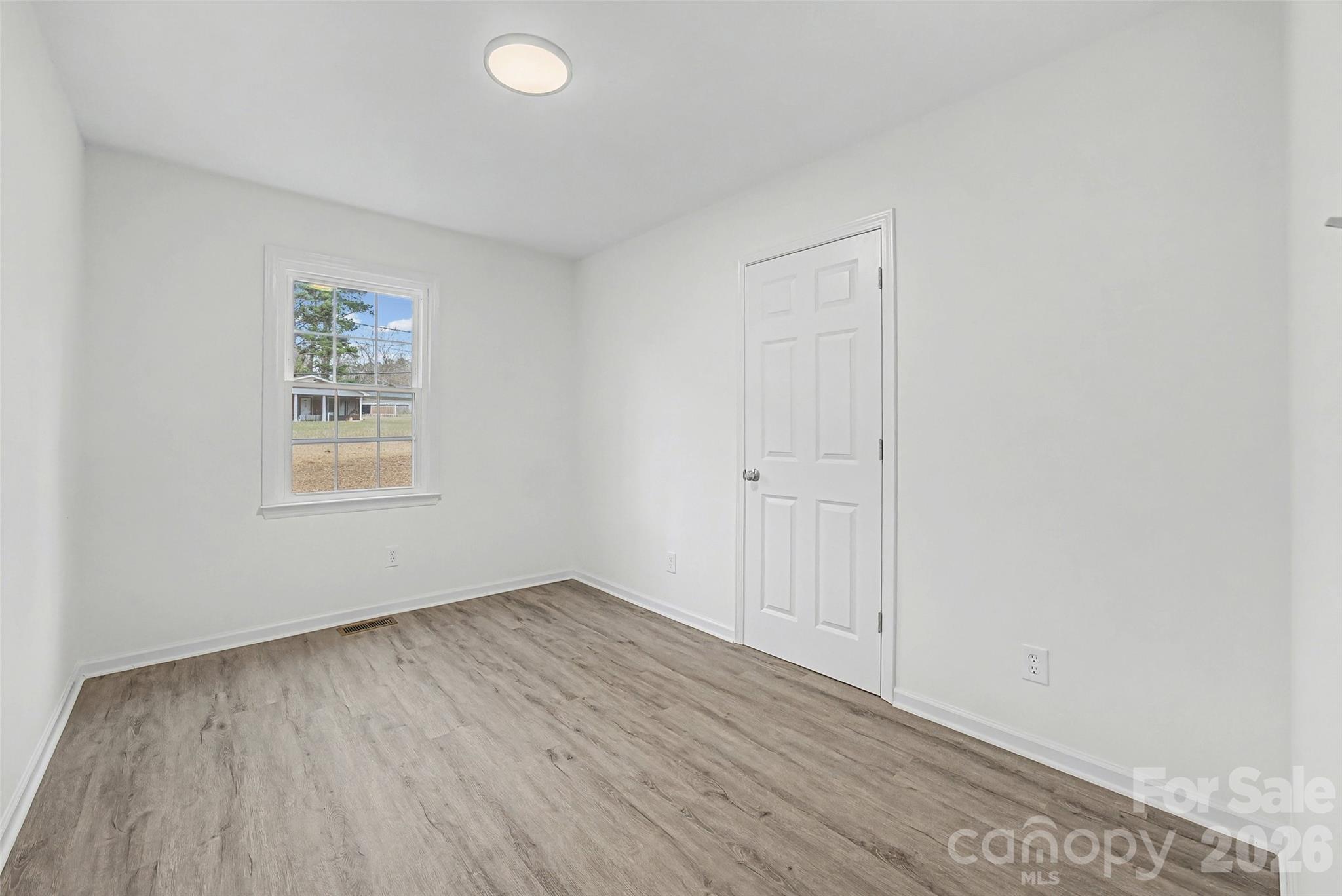 1135 Princeton Road Rock Hill, SC 29730 - Photo 7 of 20 an empty room with wooden floor and windows