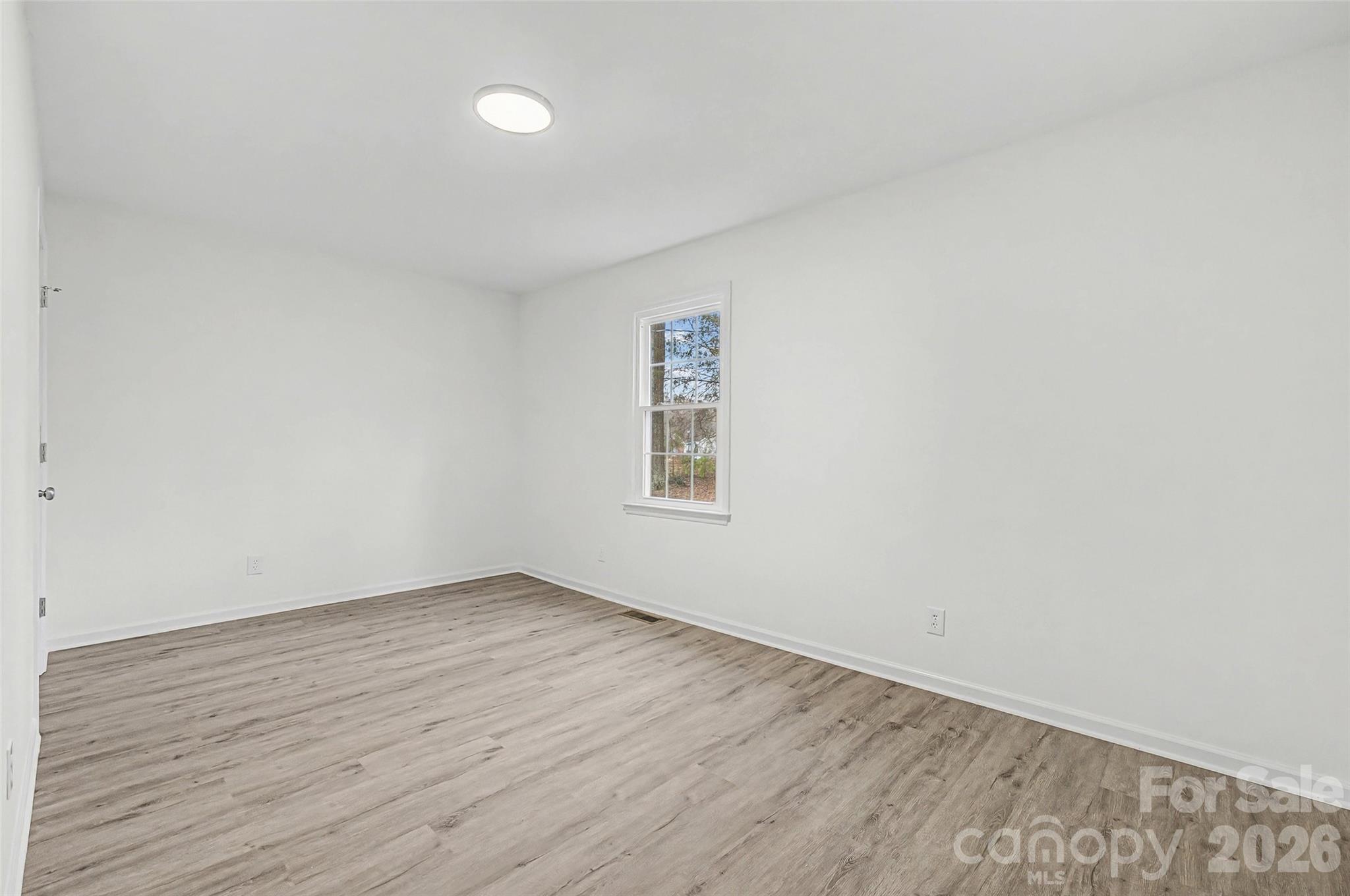 1135 Princeton Road Rock Hill, SC 29730 - Photo 10 of 20 an empty room with wooden floor and windows
