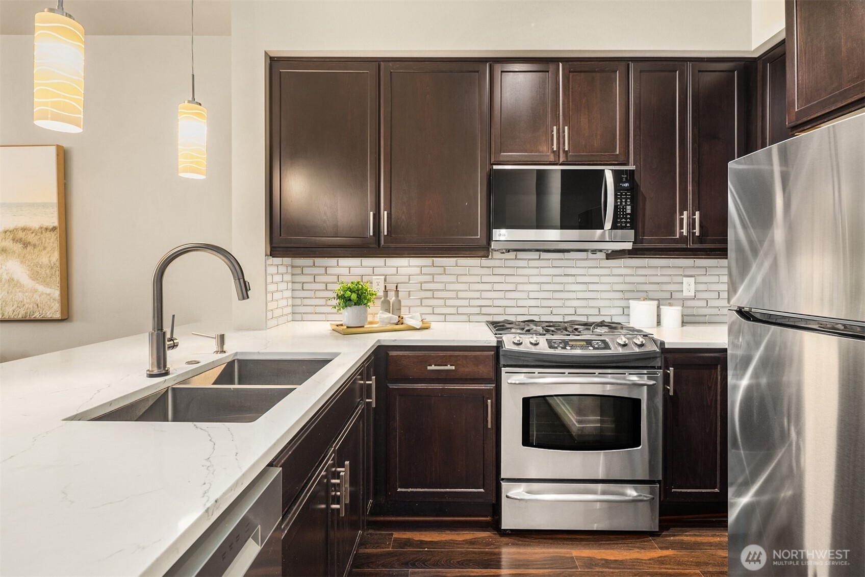 15700 116th Avenue Northeast, Unit 404 Bothell, WA 98011 - Photo 5 of 31 a kitchen with a sink stove and refrigerator