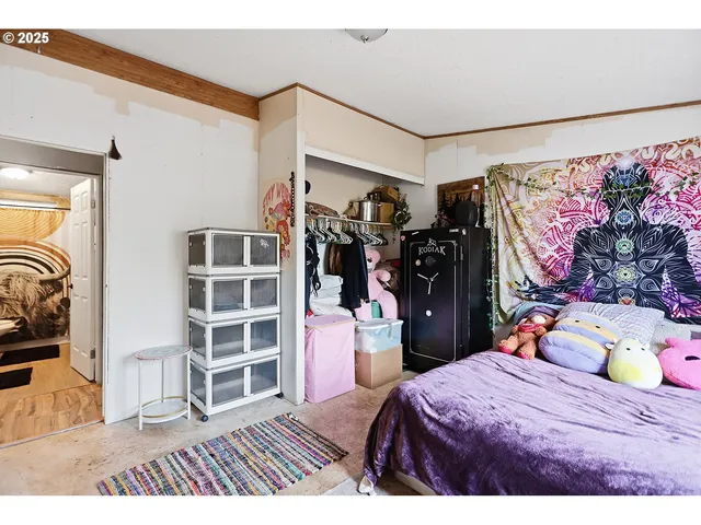 a bed room with a bed and a view of walk in closet