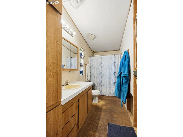 a hallway with a sink and cabinets