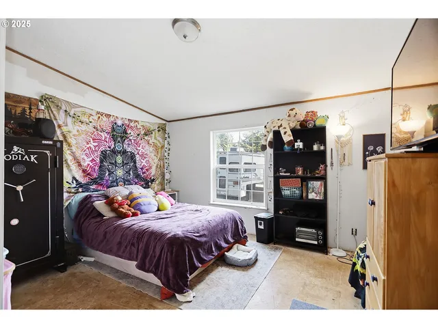a bedroom with bed and wooden floor
