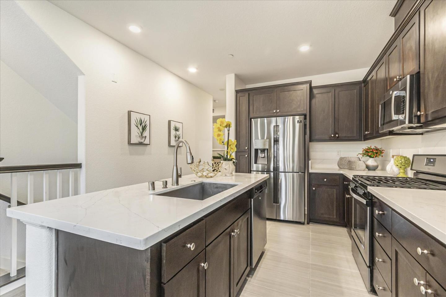 37366 Sequoia Road Fremont, CA 94536 - Photo 6 of 32 a kitchen with a sink a stove a refrigerator a center island and some cabinets