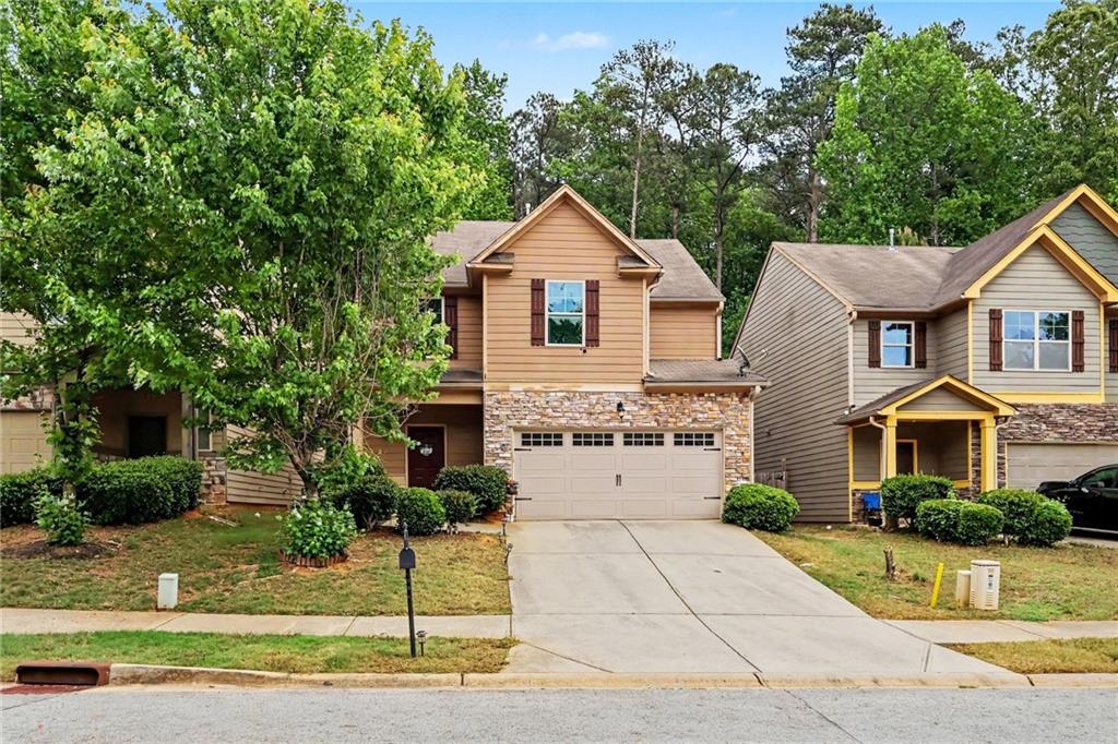 2780 Lakeview Walk Decatur, GA 30035 - Photo 2 of 37 a front view of a house with a yard and garage
