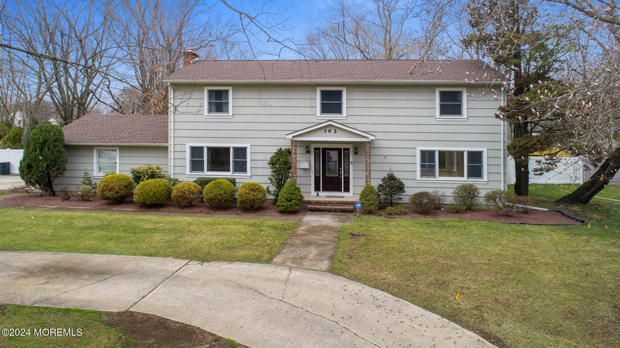 a front view of a house with a garden