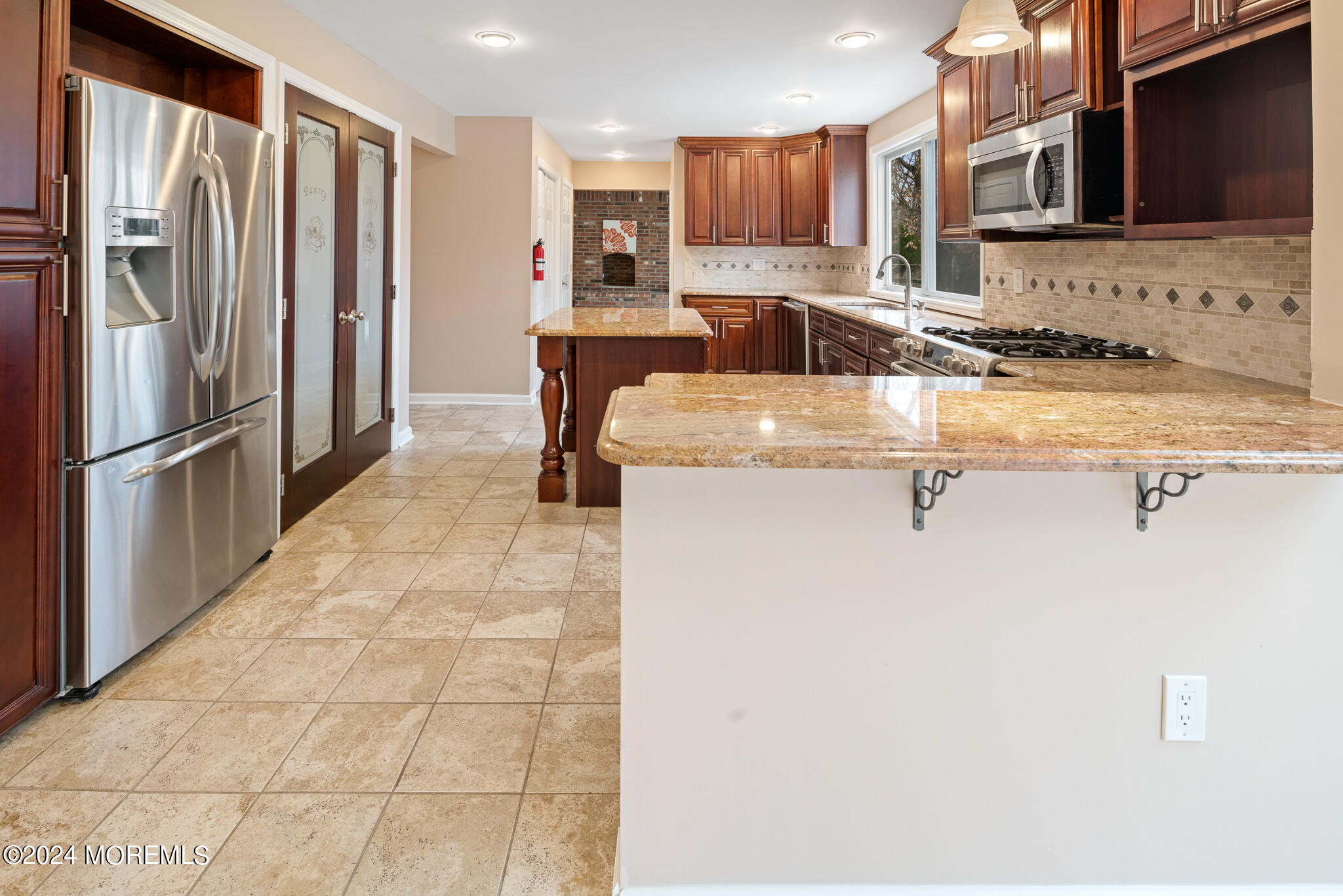 362 Elton Adelphia Road Freehold, NJ 07728 - Photo 15 of 38 a kitchen with stainless steel appliances granite countertop a sink refrigerator and cabinets