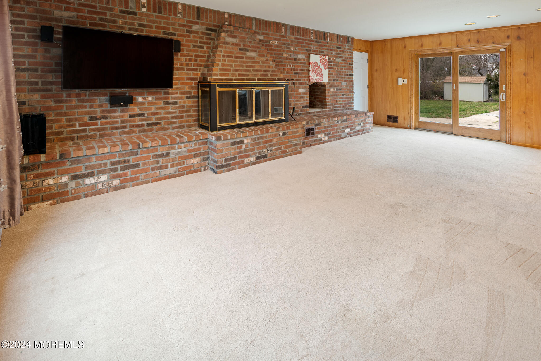 362 Elton Adelphia Road Freehold, NJ 07728 - Photo 20 of 38 a living room with fireplace and flat screen tv
