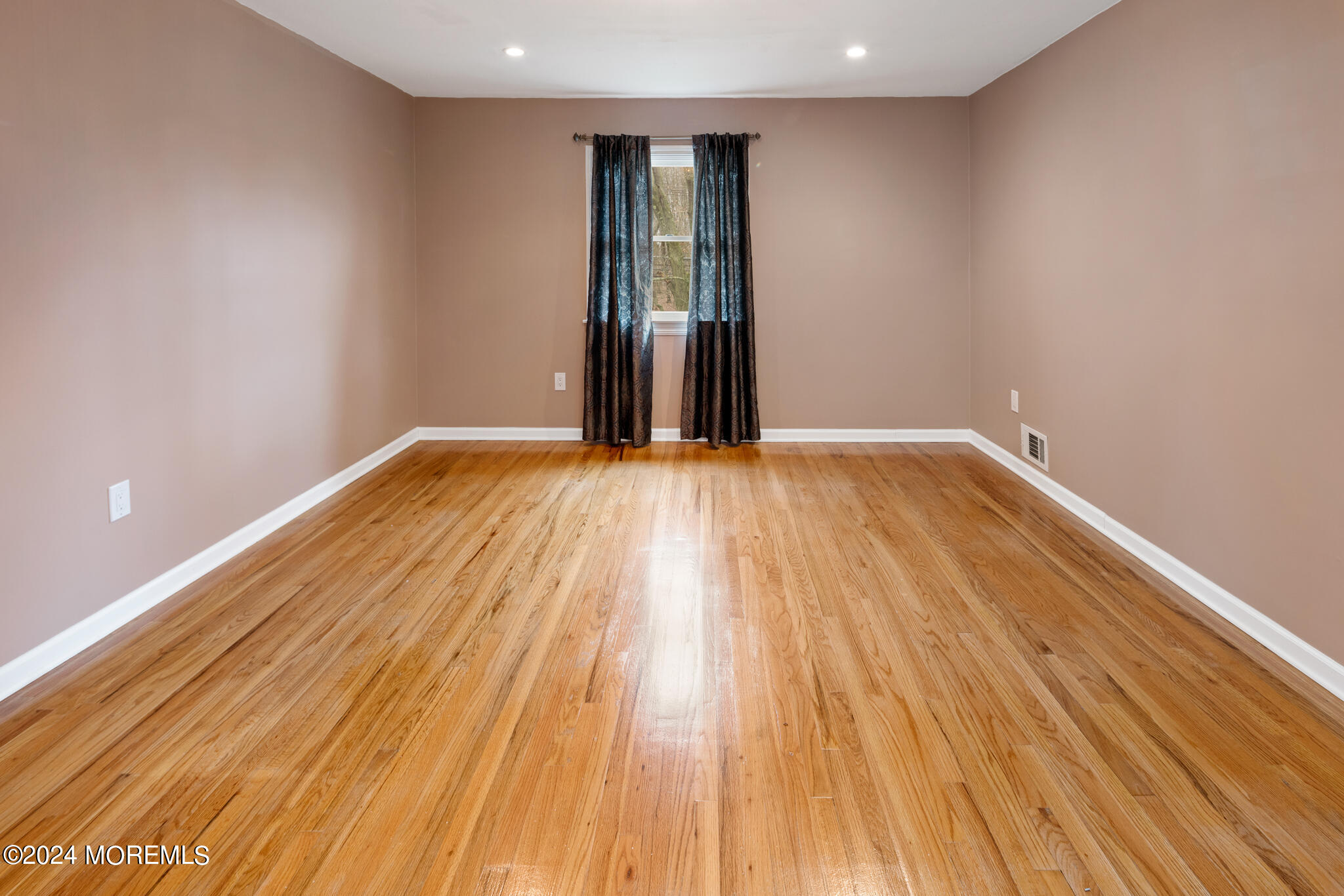 362 Elton Adelphia Road Freehold, NJ 07728 - Photo 28 of 38 a view of an empty room with wooden floor and cabinets