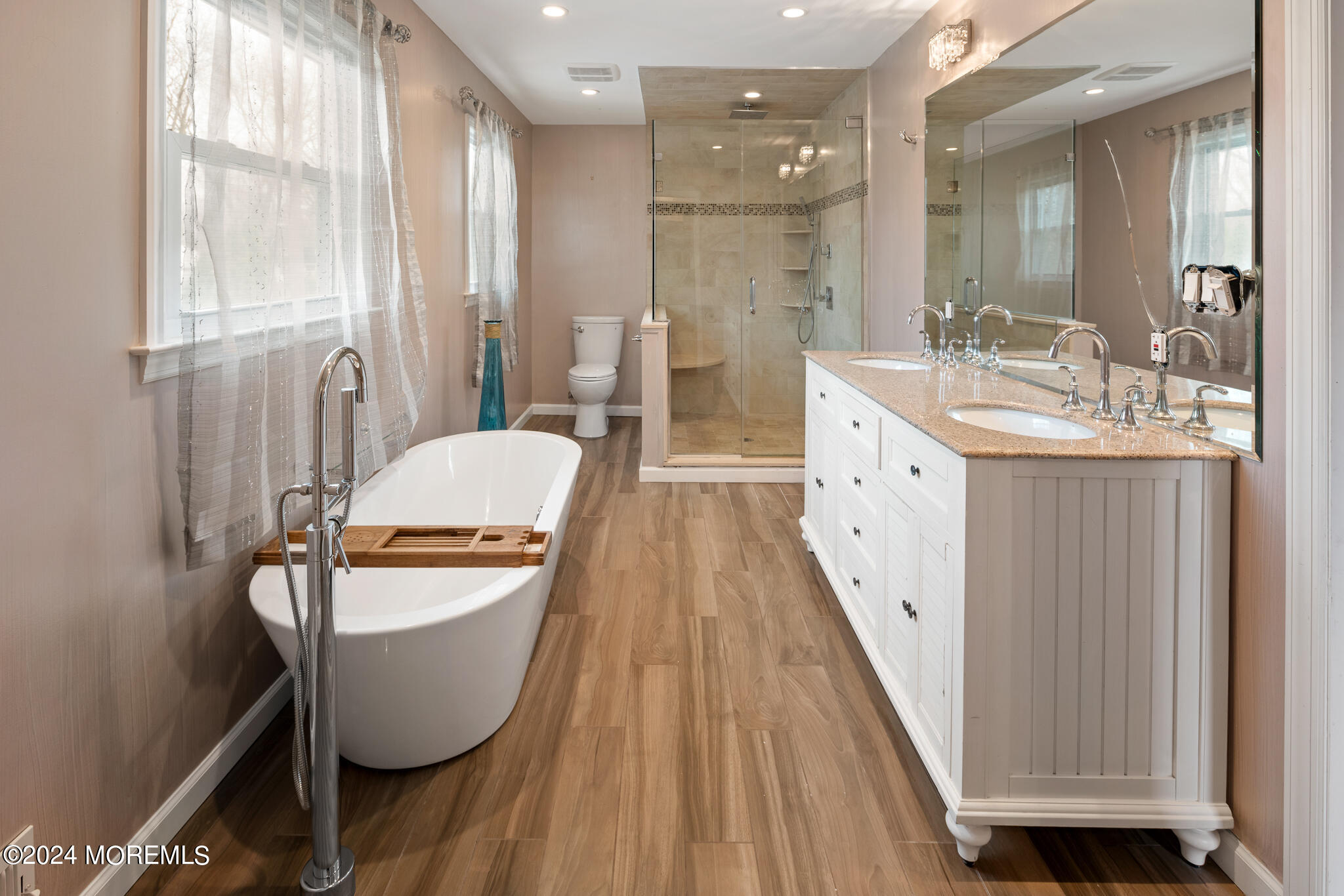 362 Elton Adelphia Road Freehold, NJ 07728 - Photo 29 of 38 a spacious bathroom with a granite countertop sink a toilet a mirror and a glass door shower
