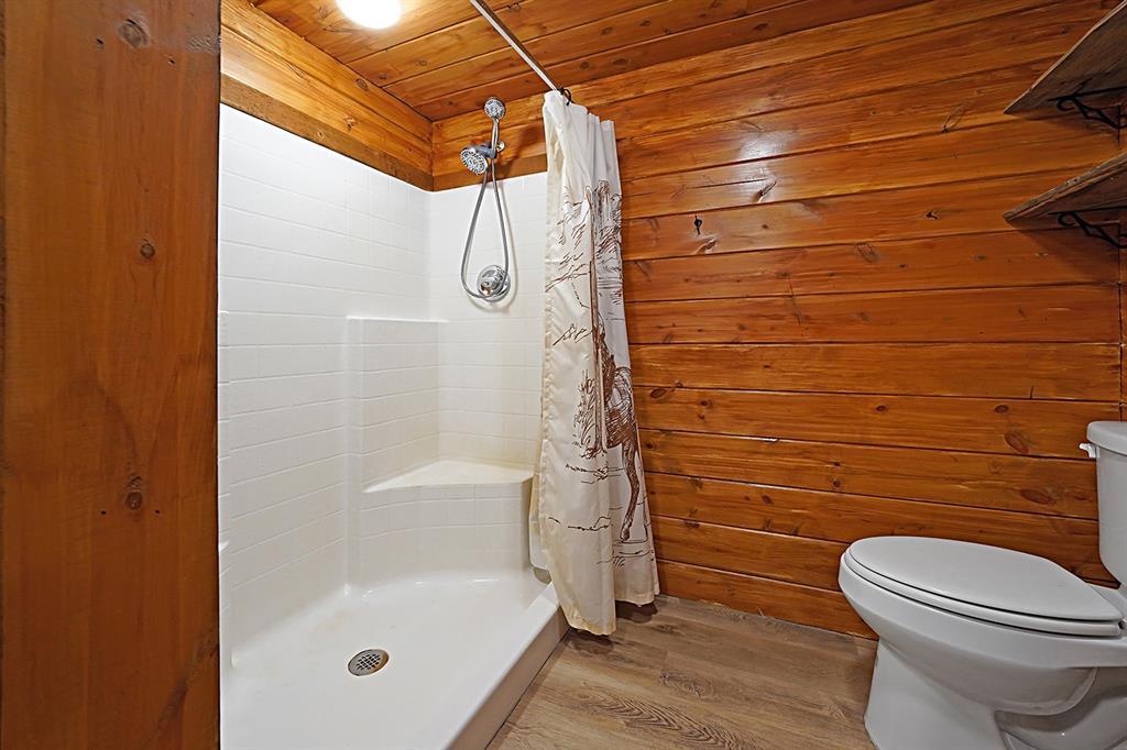 371 Spring Street Forestburg, TX 76239 - Photo 17 of 38 a bathroom with a shower a toilet and a shower