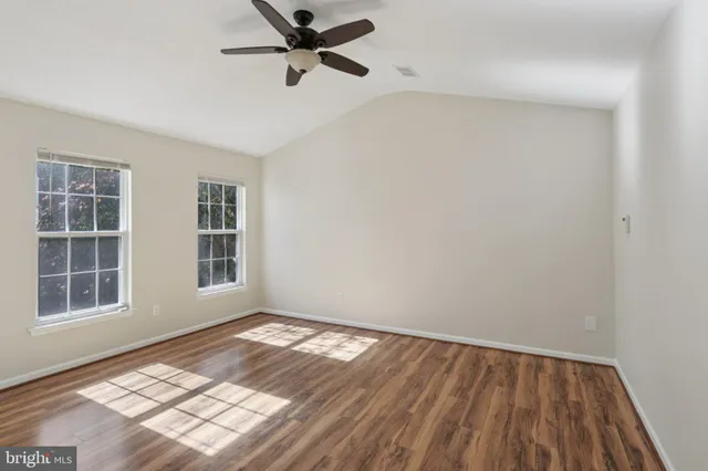 a view of staircase with white walls and a window