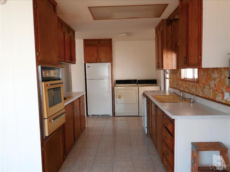 1225 South Rice Road, Unit 44 Ojai, CA 93023 - Photo 4 of 5 a kitchen with a sink refrigerator and microwave