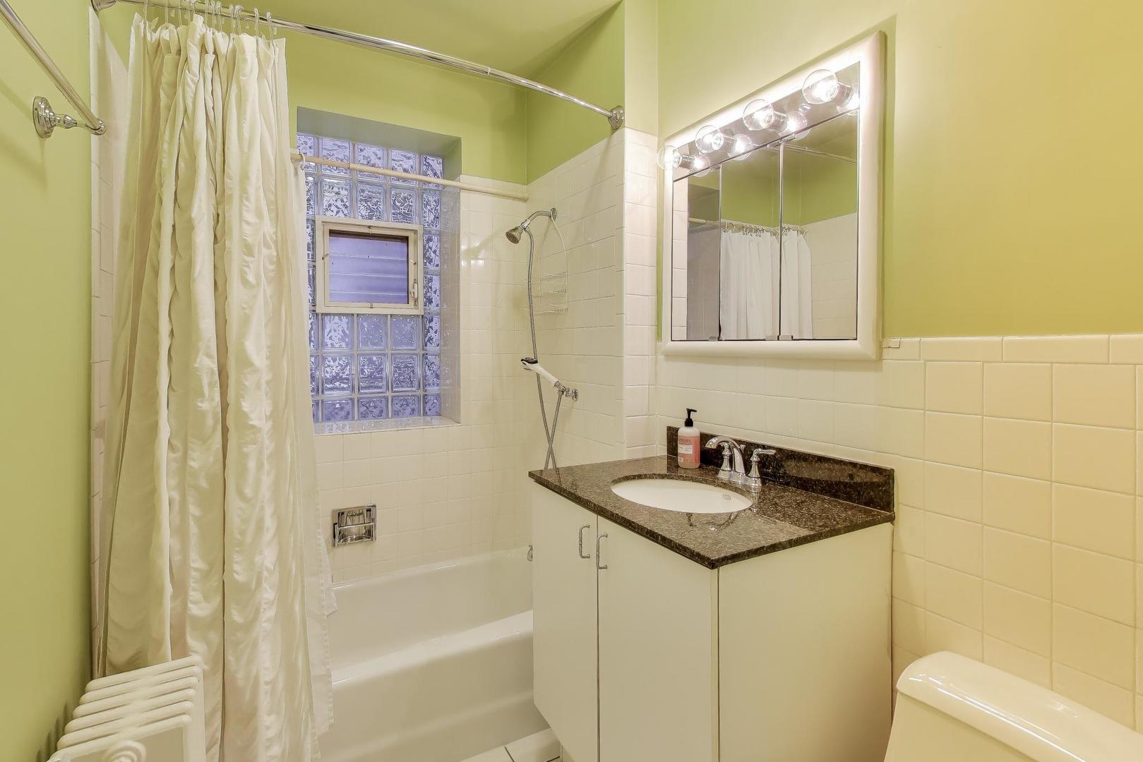 2245 West Giddings Street Chicago, IL 60625 - Photo 13 of 50 a bathroom with a granite countertop sink and a mirror