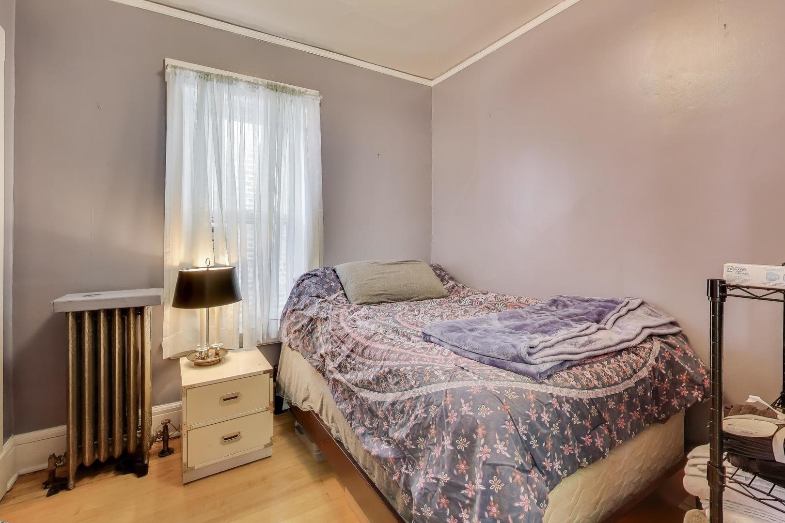 2245 West Giddings Street Chicago, IL 60625 - Photo 30 of 50 a bedroom with a bed and wooden floor