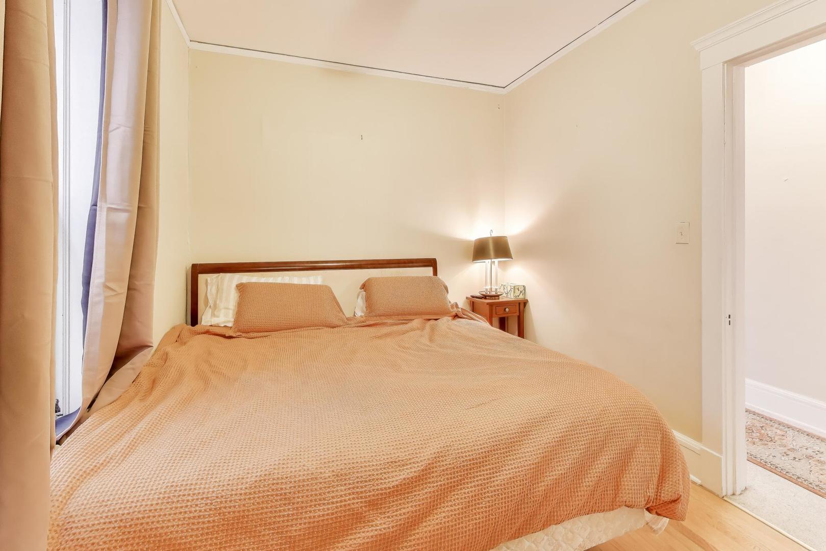 2245 West Giddings Street Chicago, IL 60625 - Photo 34 of 50 a large bed sitting in a bedroom next to a window